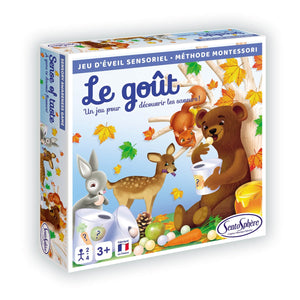 Enfant manipulant les jetons du jeu sensoriel Le Goût pour reconnaître les saveurs